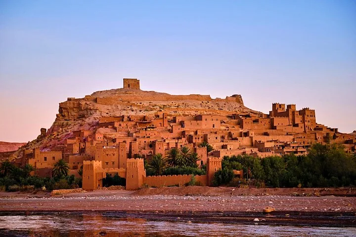 Ait Benhaddou, a traditional mud-brick kasbah in Morocco, glowing at sunset